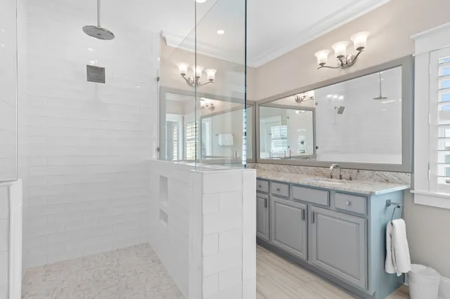a bathroom with a granite countertop sink shower and a mirror