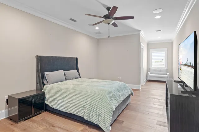 a bedroom with a large bed and a chandelier