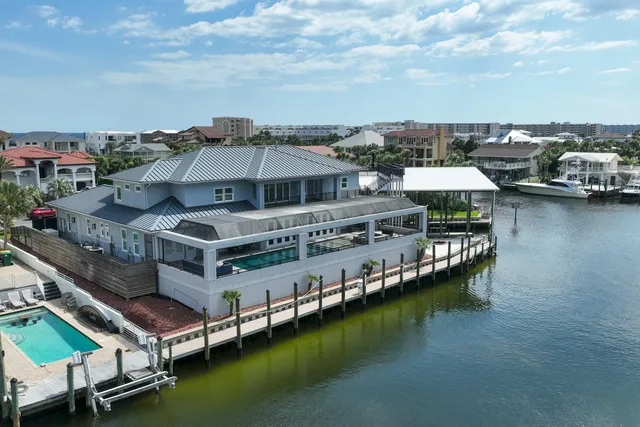 a roof deck with table and chairs under an umbrella