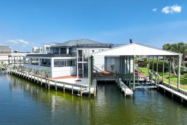an aerial view of a house with a garden and lake view