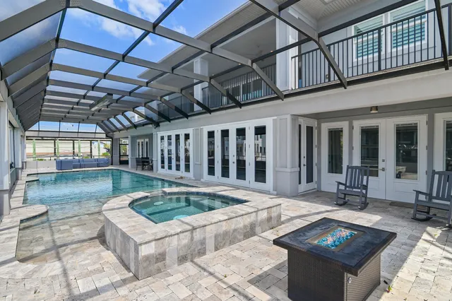 a sitting area with pool table and glass windows