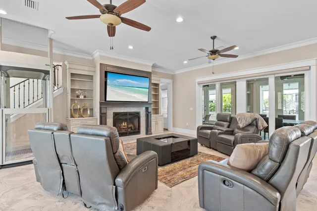a living room with furniture ceiling fan and a fireplace