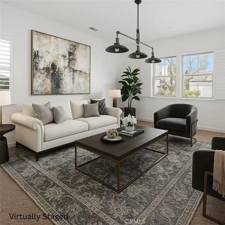 a living room with furniture potted plant and window