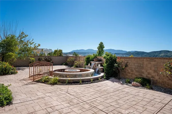 a front view of a house with swimming pool having outdoor seating