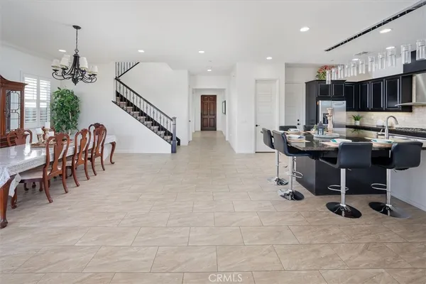 a dining room with furniture potted plants and wooden floor
