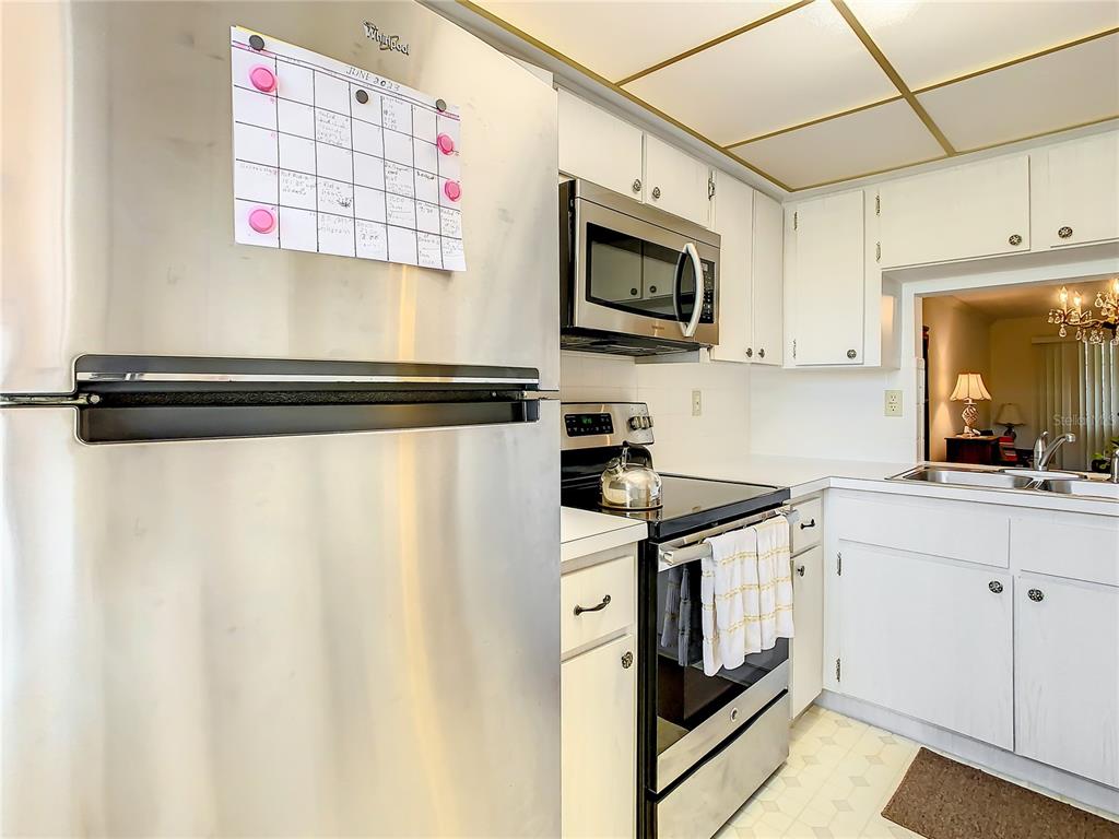 4230 Redcliff Place, Unit 4230 New Port Richey, FL 34652 - Photo 4 of 42 a kitchen with stainless steel appliances a sink a stove and cabinets