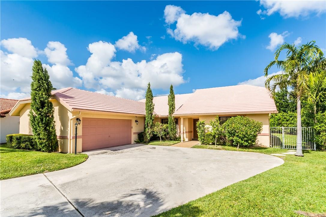 22870 Greenview Terrace Boca Raton, FL 33433 - Photo 2 of 57 a front view of a house with a yard and garage