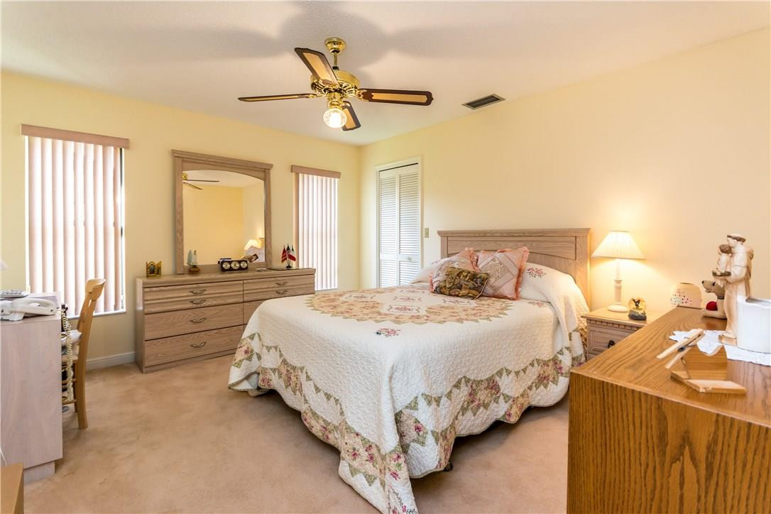22870 Greenview Terrace Boca Raton, FL 33433 - Photo 27 of 57 a bedroom with a bed and a chandelier