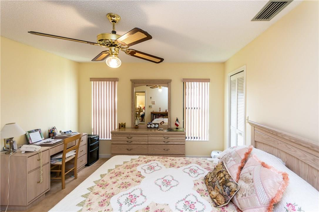 22870 Greenview Terrace Boca Raton, FL 33433 - Photo 28 of 57 a bedroom with a bed and a chandelier