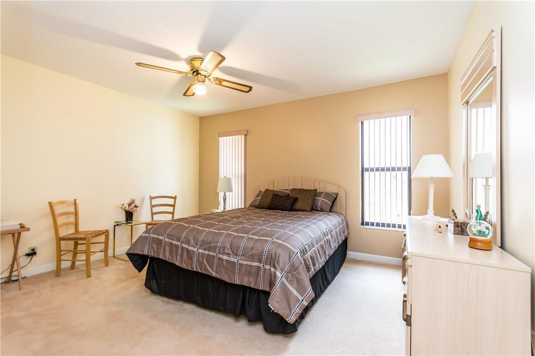 22870 Greenview Terrace Boca Raton, FL 33433 - Photo 30 of 57 a bedroom with a bed and a chandelier