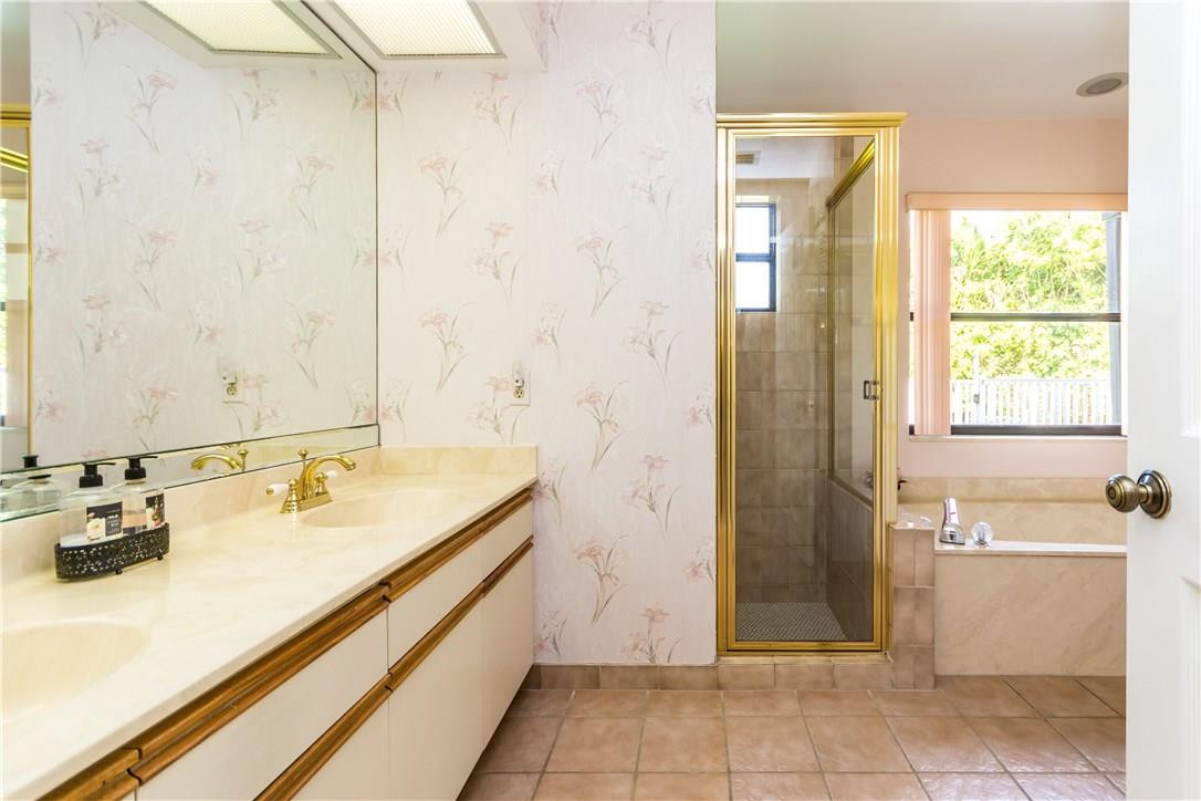 22870 Greenview Terrace Boca Raton, FL 33433 - Photo 32 of 57 a bathroom with a tub sink and mirror