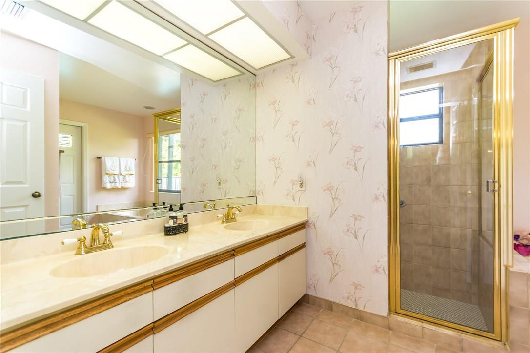 22870 Greenview Terrace Boca Raton, FL 33433 - Photo 33 of 57 a bathroom with a double vanity sink mirror and shower