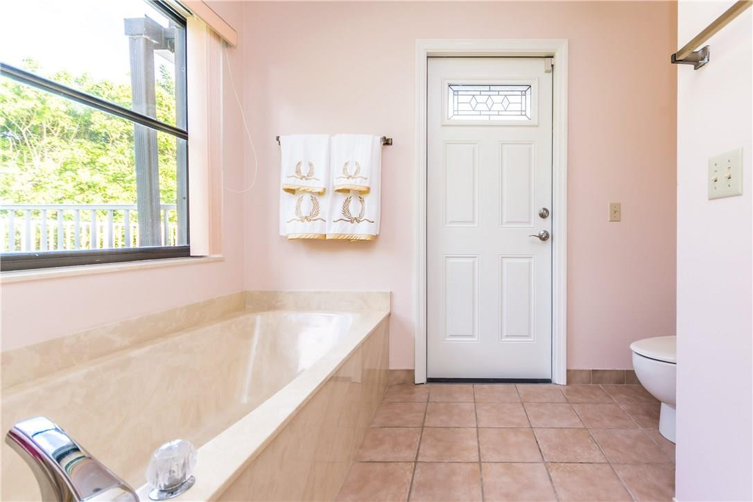 22870 Greenview Terrace Boca Raton, FL 33433 - Photo 34 of 57 a bathroom with a bathtub and a toilet