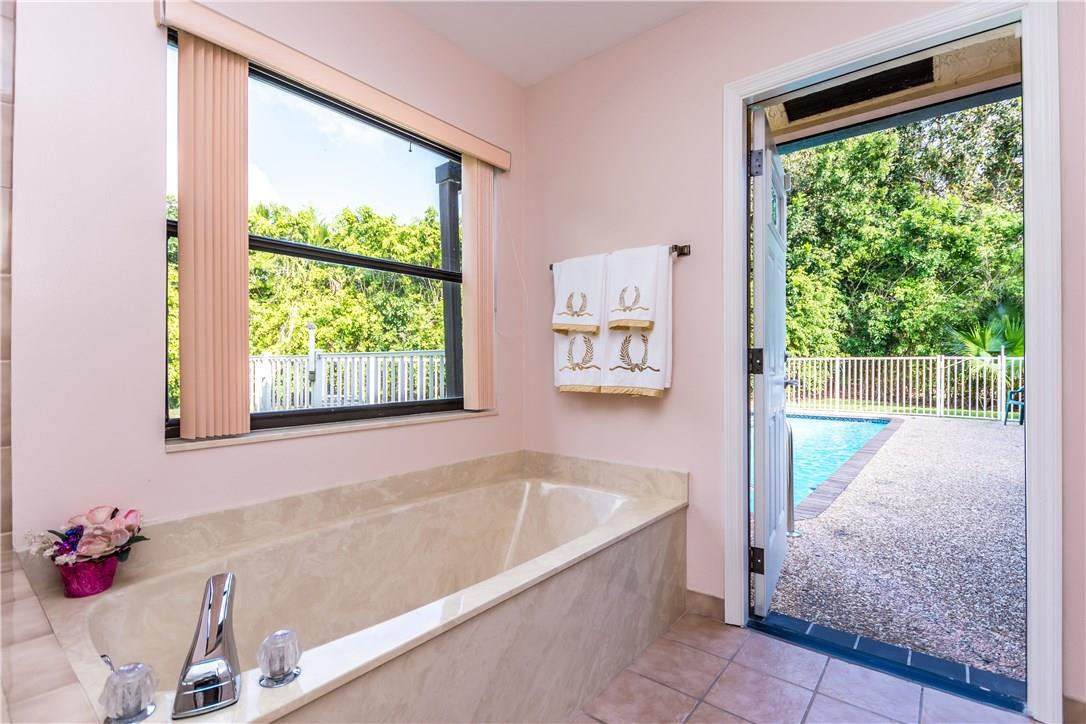 22870 Greenview Terrace Boca Raton, FL 33433 - Photo 36 of 57 a bath tub sitting in a bathroom next to a window