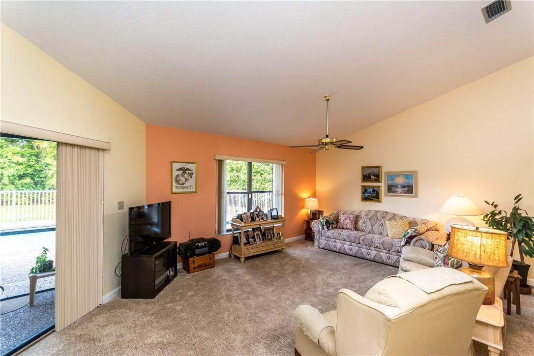 22870 Greenview Terrace Boca Raton, FL 33433 - Photo 37 of 57 a living room with furniture a window and a flat screen tv