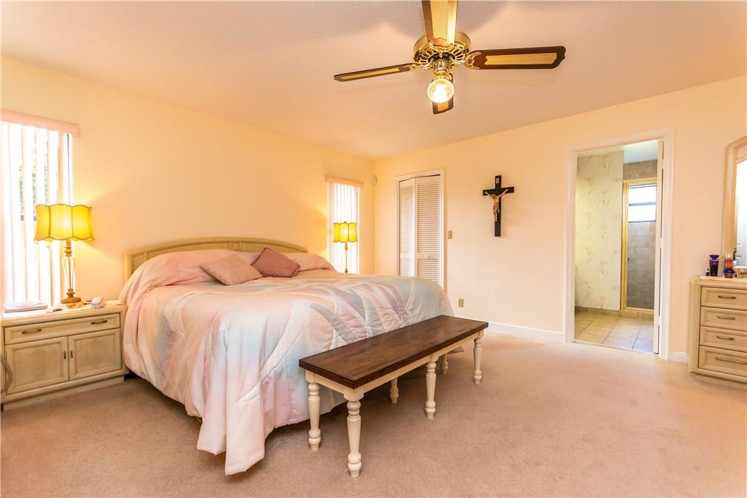 22870 Greenview Terrace Boca Raton, FL 33433 - Photo 38 of 57 a bedroom with a bed and a chandelier
