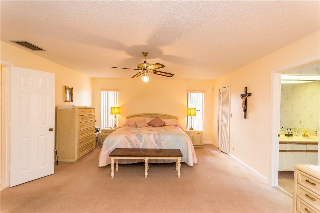 22870 Greenview Terrace Boca Raton, FL 33433 - Photo 45 of 57 a bed room with a bed and a chandelier