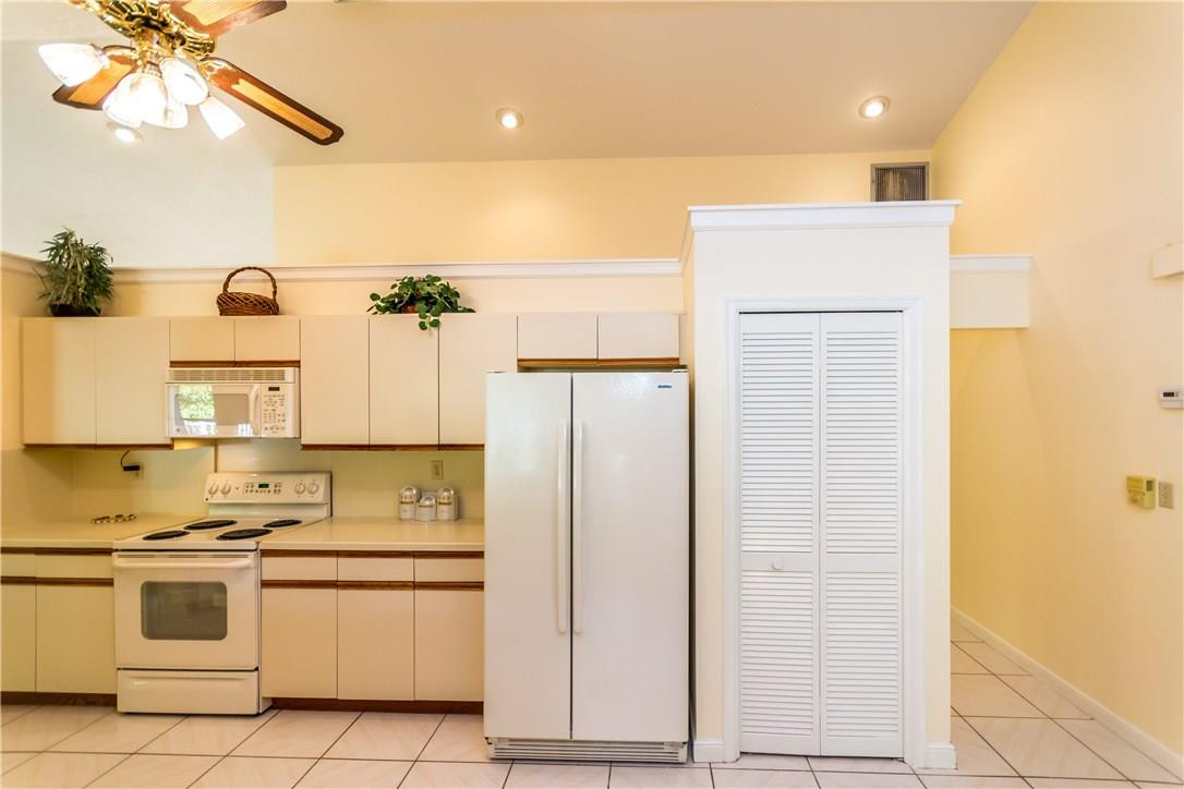 22870 Greenview Terrace Boca Raton, FL 33433 - Photo 46 of 57 a kitchen with a refrigerator and a sink