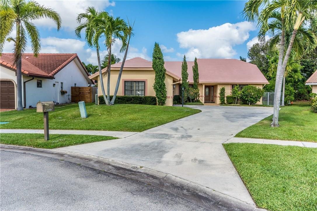 22870 Greenview Terrace Boca Raton, FL 33433 - Photo 56 of 57 a view of a house with a yard and palm trees
