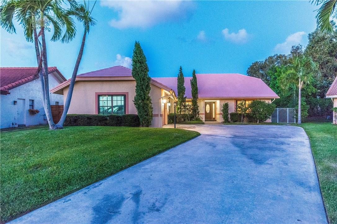22870 Greenview Terrace Boca Raton, FL 33433 - Photo 57 of 57 a view of a yard in front of a house with plants and large tree
