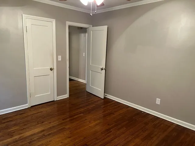 a view of an empty room with wooden floor