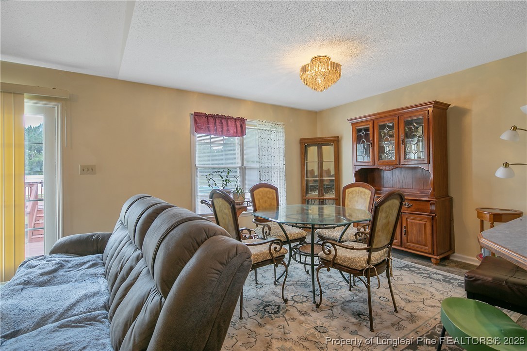 6042 Elliott Bridge Road Linden, NC 28356 - Photo 11 of 47 a view of a dining room with furniture and chandelier