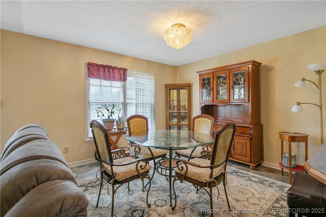 6042 Elliott Bridge Road Linden, NC 28356 - Photo 14 of 47 a view of a dining room with furniture and chandelier