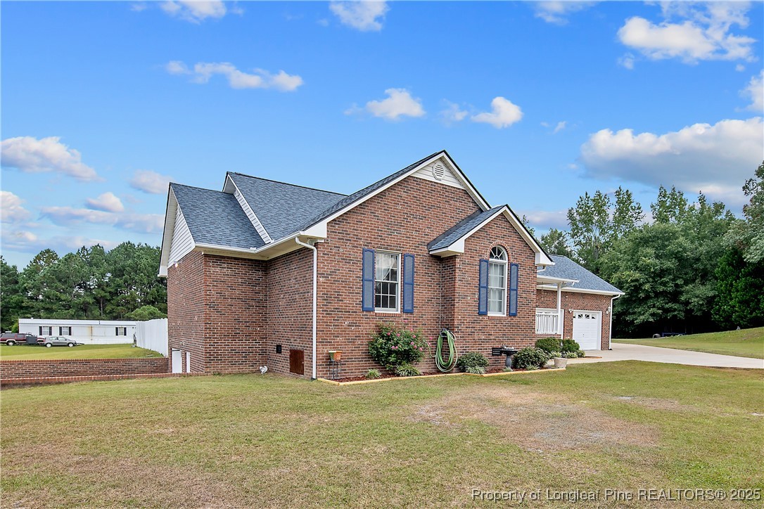 6042 Elliott Bridge Road Linden, NC 28356 - Photo 2 of 47 a front view of a house with a yard