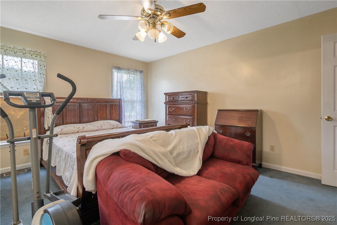 6042 Elliott Bridge Road Linden, NC 28356 - Photo 22 of 47 a bedroom with bed and wooden floor