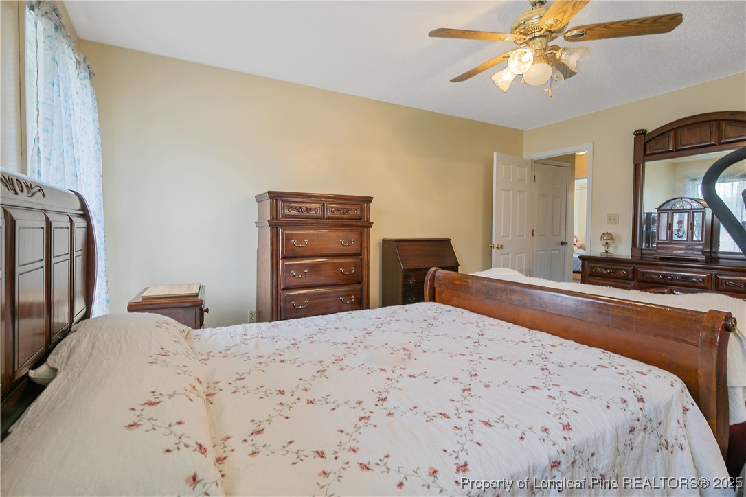 6042 Elliott Bridge Road Linden, NC 28356 - Photo 23 of 47 a bedroom with a bed and a dresser