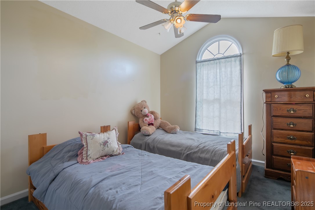 6042 Elliott Bridge Road Linden, NC 28356 - Photo 27 of 47 a bedroom with two beds and a chandelier