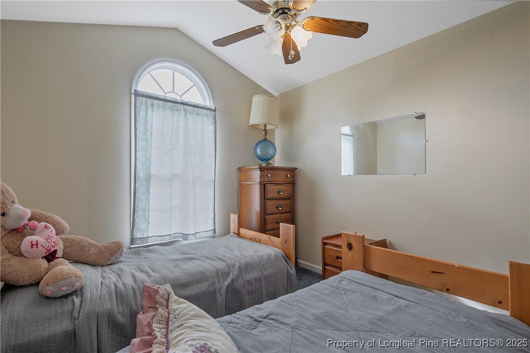 6042 Elliott Bridge Road Linden, NC 28356 - Photo 28 of 47 a bedroom with two beds and a chandelier