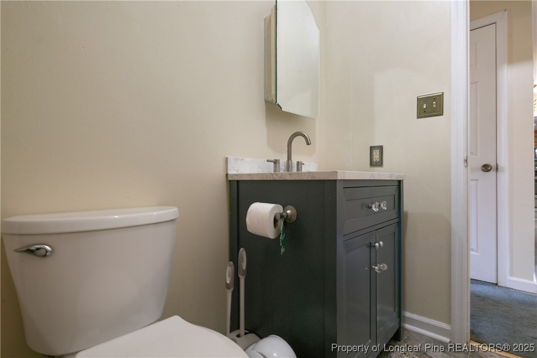 6042 Elliott Bridge Road Linden, NC 28356 - Photo 31 of 47 a bathroom with a toilet and a sink