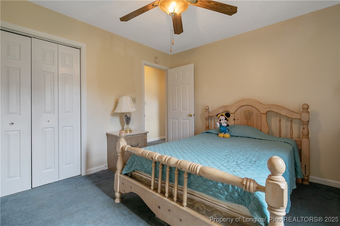 6042 Elliott Bridge Road Linden, NC 28356 - Photo 34 of 47 a bedroom with bed and a chandelier