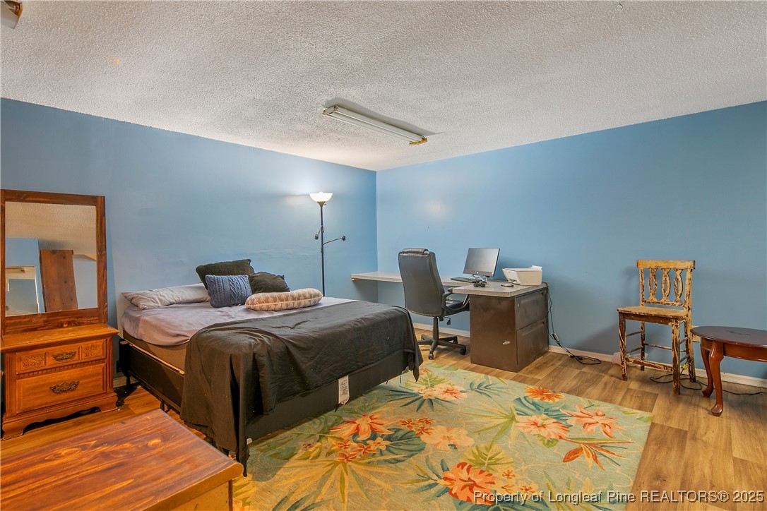 6042 Elliott Bridge Road Linden, NC 28356 - Photo 37 of 47 a bedroom with a bed and a table in it