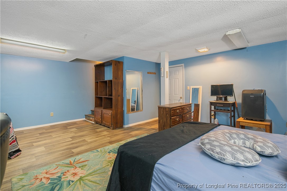 6042 Elliott Bridge Road Linden, NC 28356 - Photo 39 of 47 a bedroom with a large bed and dresser