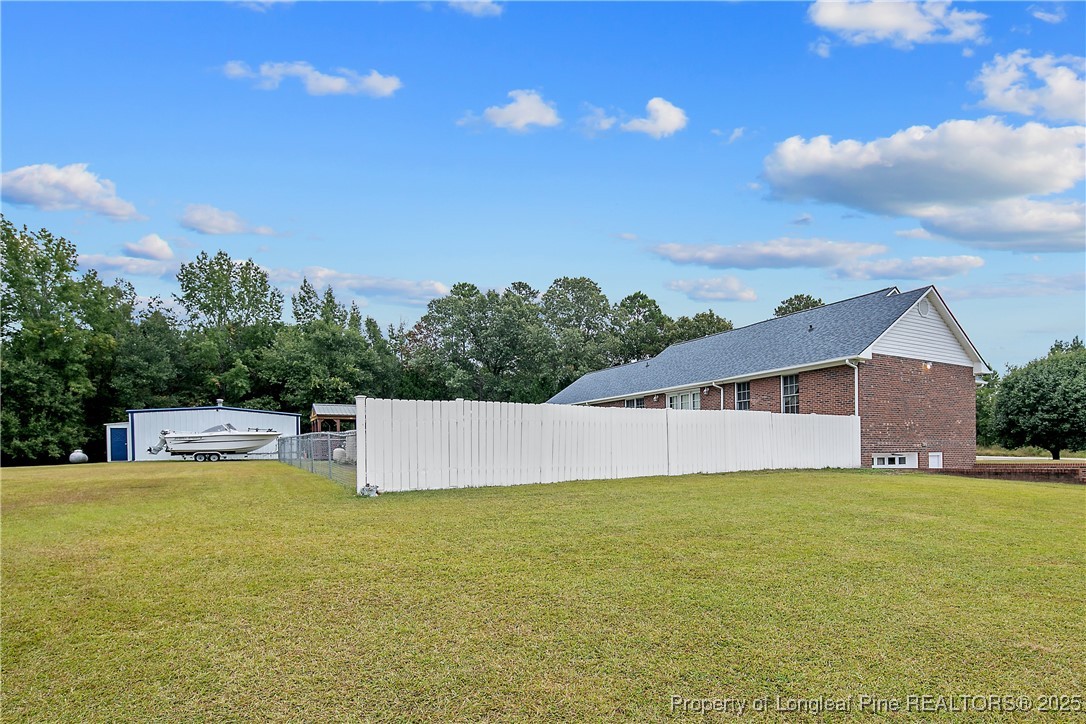 6042 Elliott Bridge Road Linden, NC 28356 - Photo 42 of 47 a view of a house with swimming pool and an outdoor space
