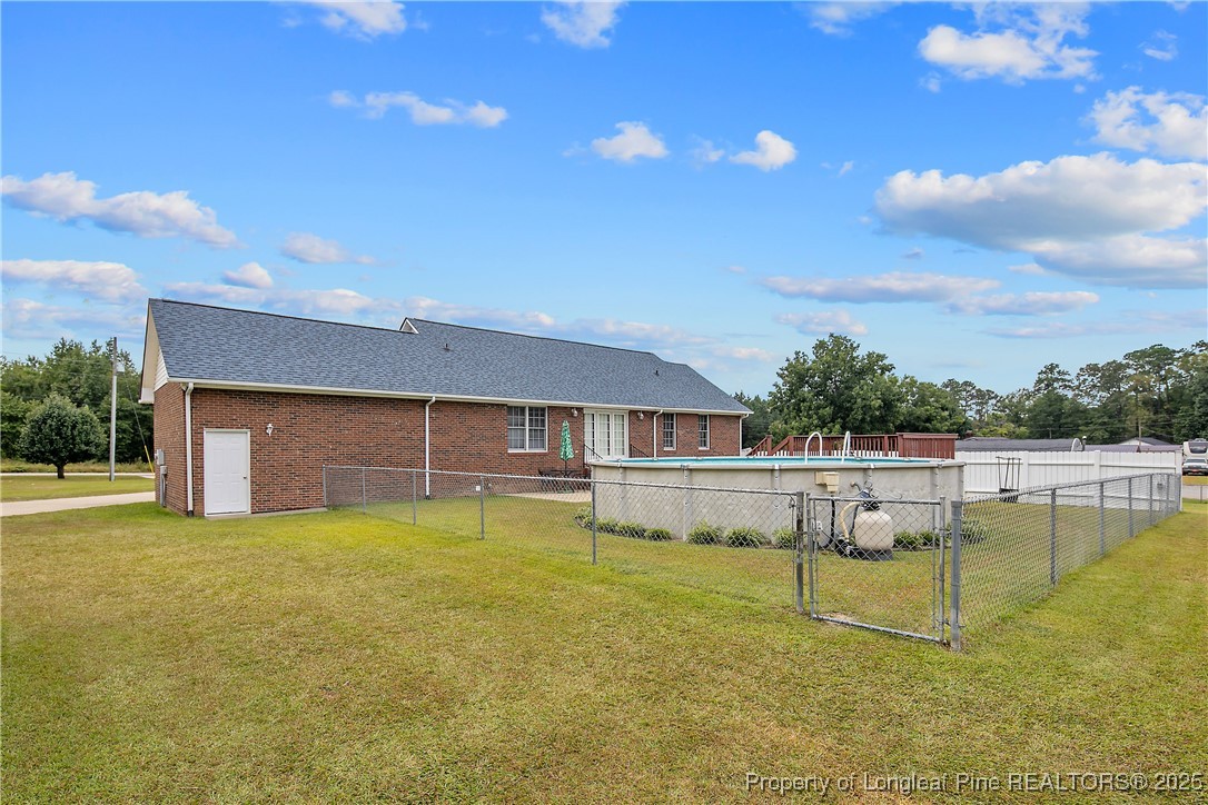 6042 Elliott Bridge Road Linden, NC 28356 - Photo 43 of 47 a view of a swimming pool with a table and chairs