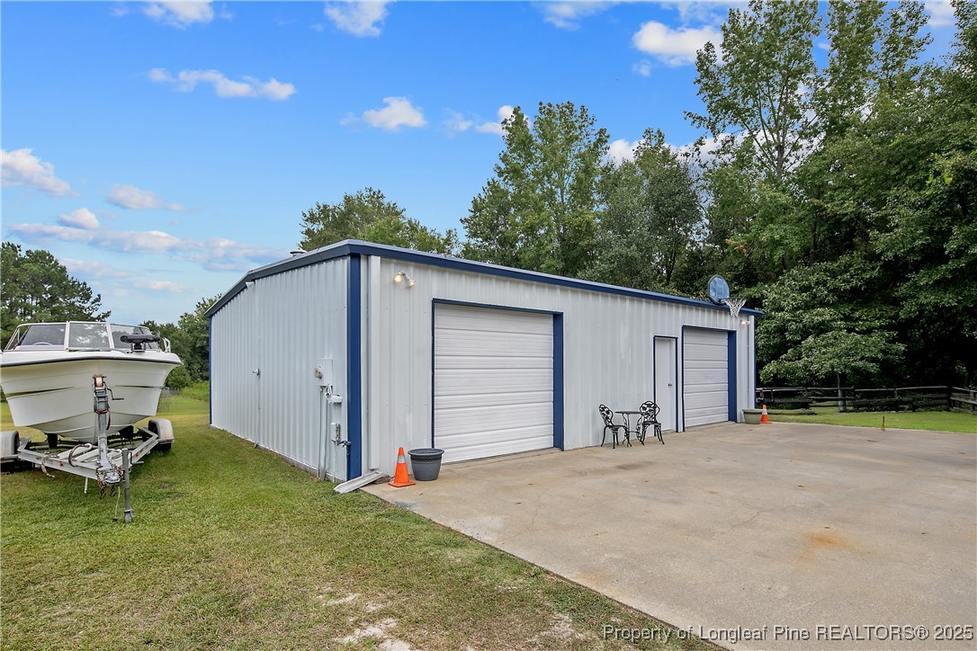 6042 Elliott Bridge Road Linden, NC 28356 - Photo 46 of 47 a view of a house with backyard and trees