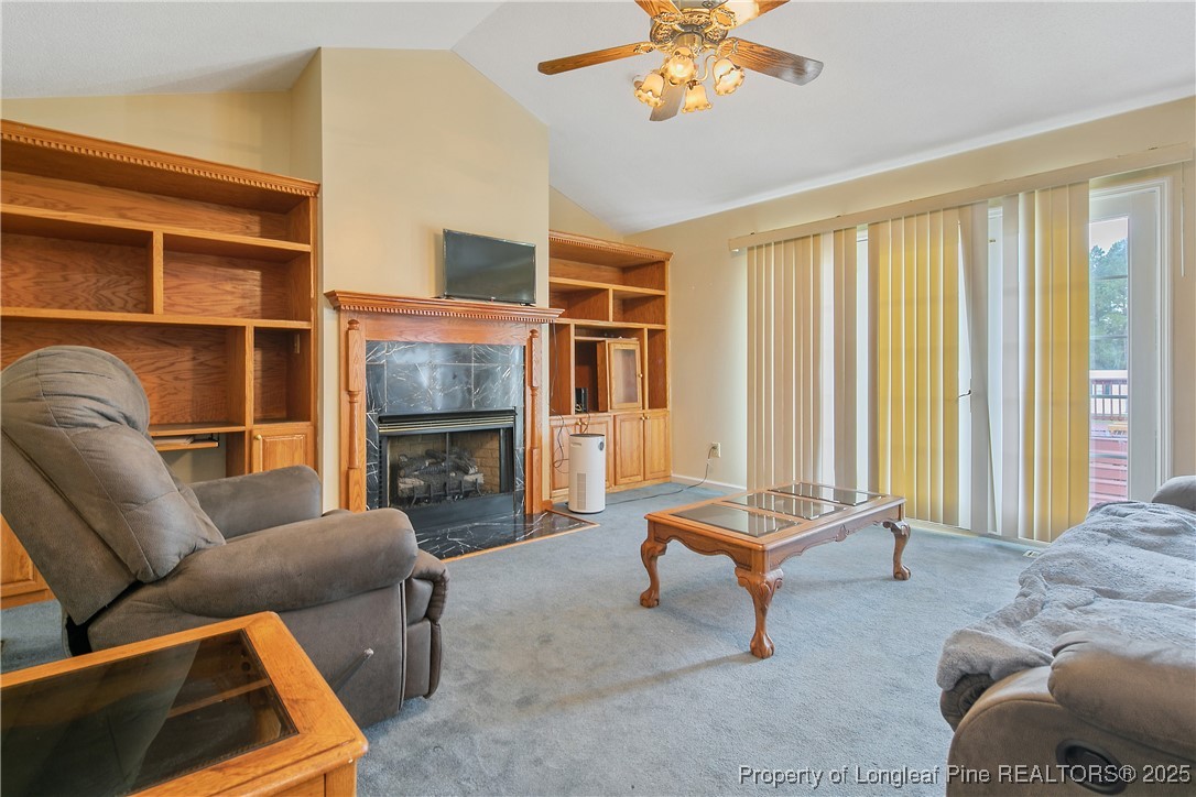 6042 Elliott Bridge Road Linden, NC 28356 - Photo 7 of 47 a living room with furniture a fireplace and a window