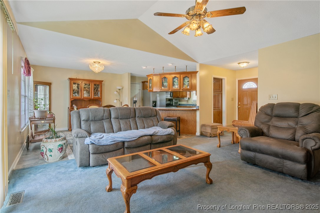 6042 Elliott Bridge Road Linden, NC 28356 - Photo 9 of 47 a living room with furniture and a chandelier