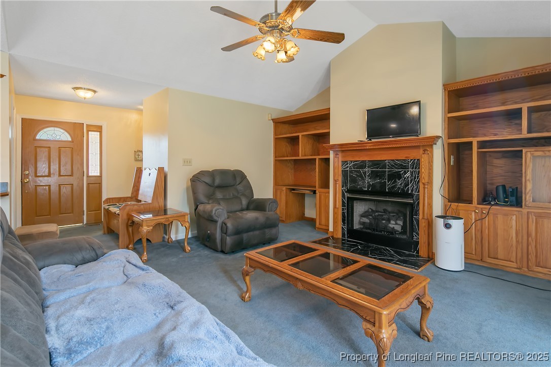 6042 Elliott Bridge Road Linden, NC 28356 - Photo 10 of 47 a living room with furniture a flat screen tv and a fireplace