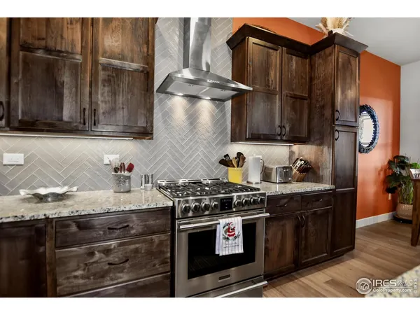 a kitchen with granite countertop a stove and cabinets