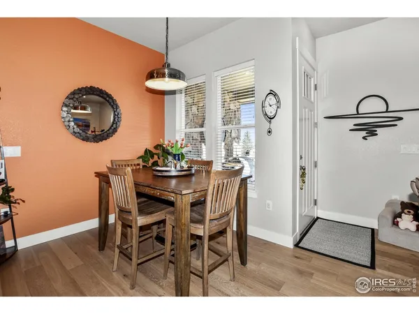 a dining room with furniture and a mirror