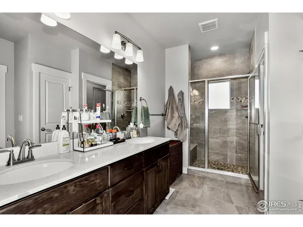 a bathroom with a sink double vanity and a shower