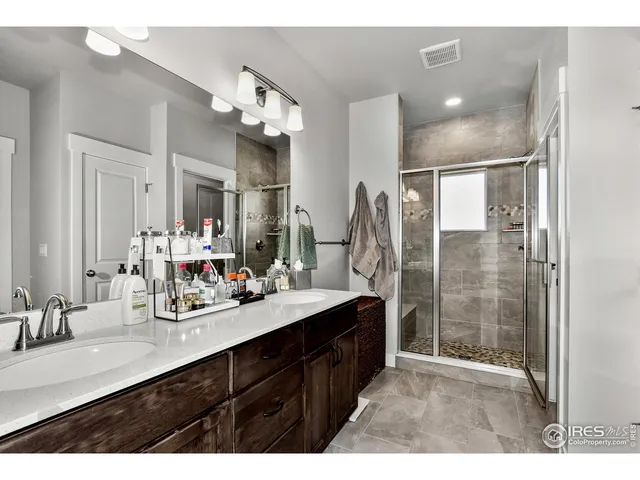 a bathroom with a sink double vanity and a shower