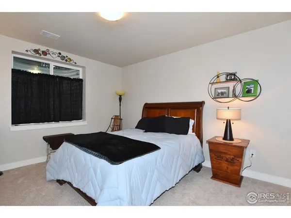 a bedroom with a bed and a night stand