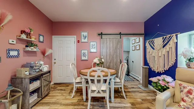 a dining room with furniture and wooden floor