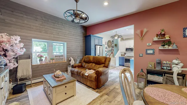 a living room with furniture and a chandelier