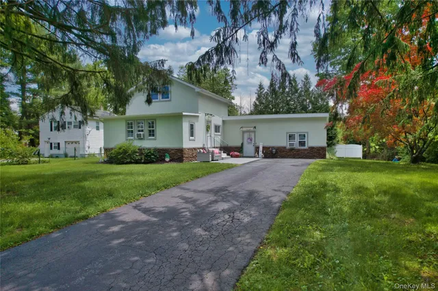 a front view of house with yard and green space